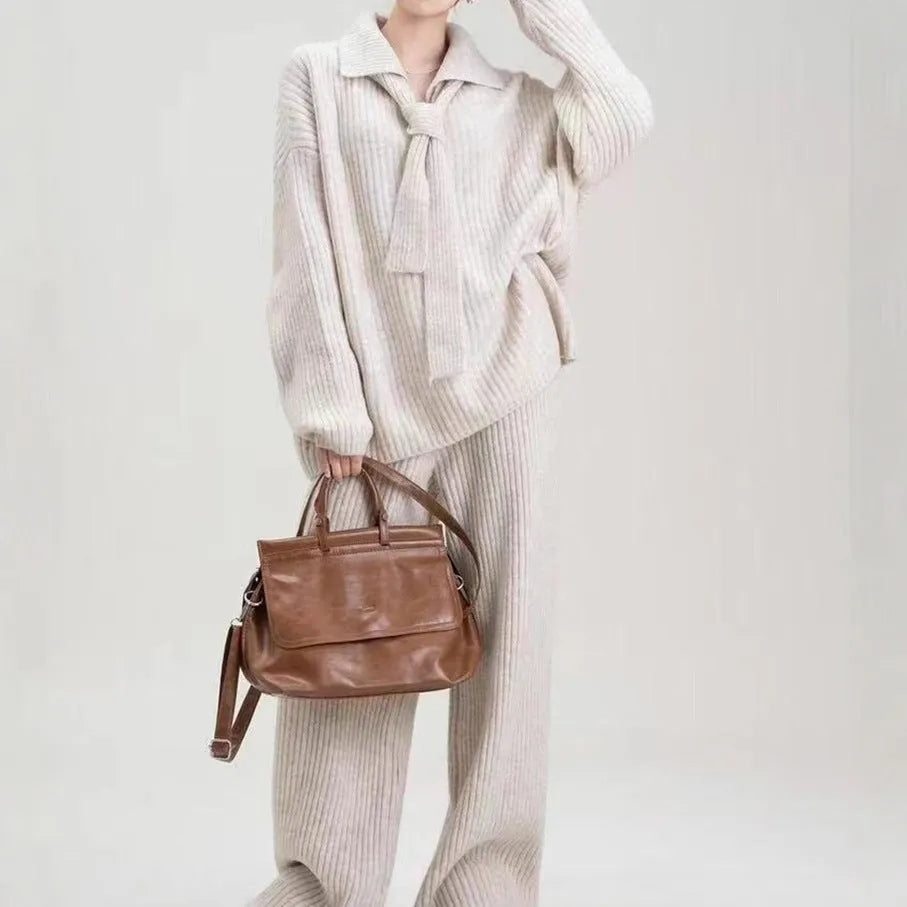 A dark grey sweater suit two-piece set featuring a long-sleeved knit top and matching casual trousers.