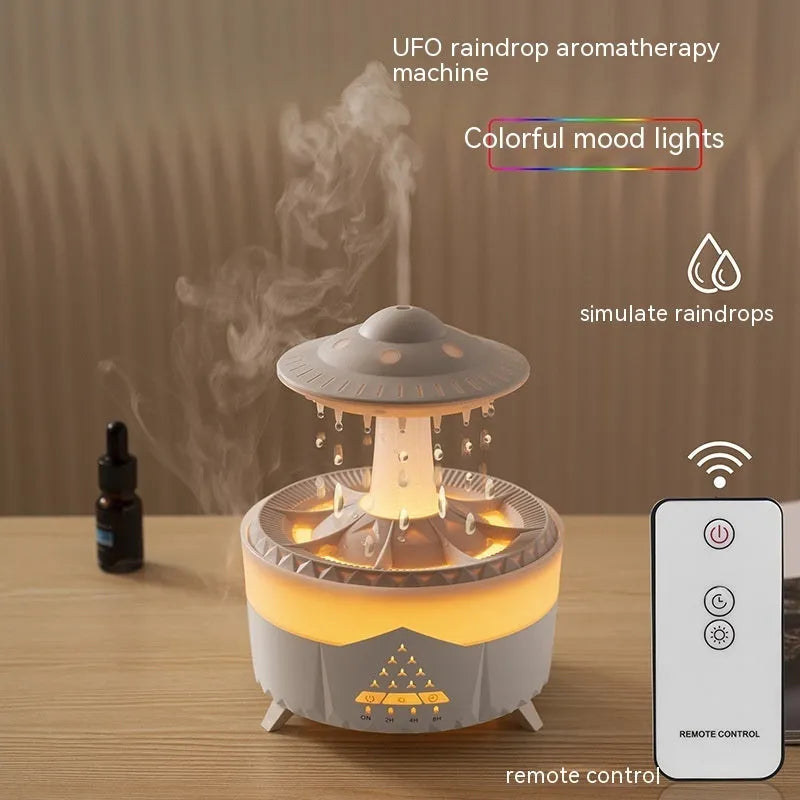 White cloud-shaped humidifier with water droplets and coloured lights on wooden surface