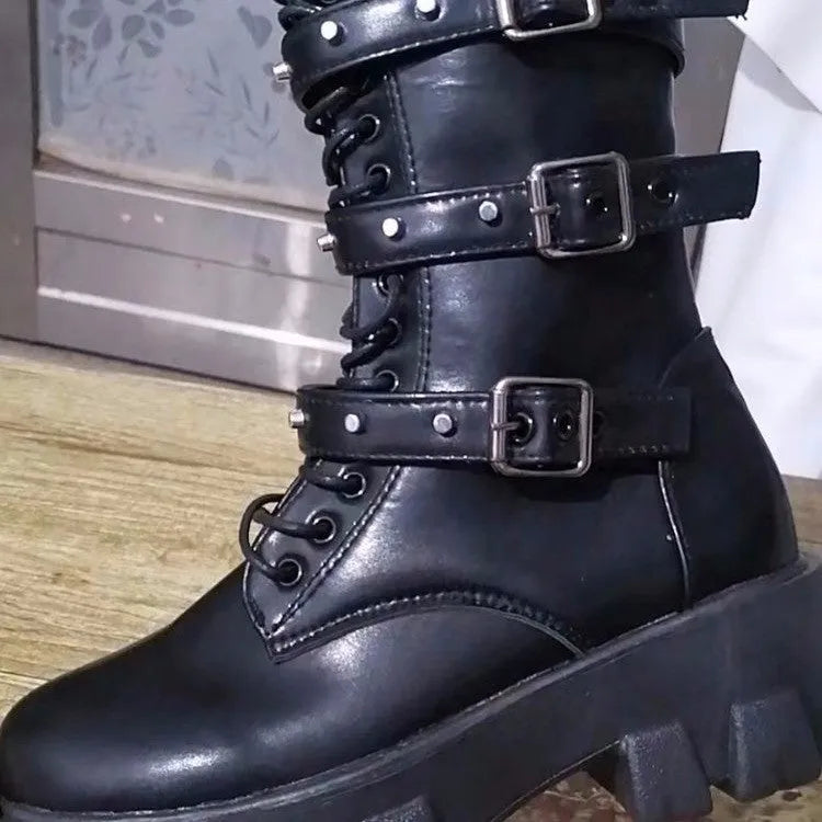 Women's black mid-calf knight boots with a large metal buckle and side zip.