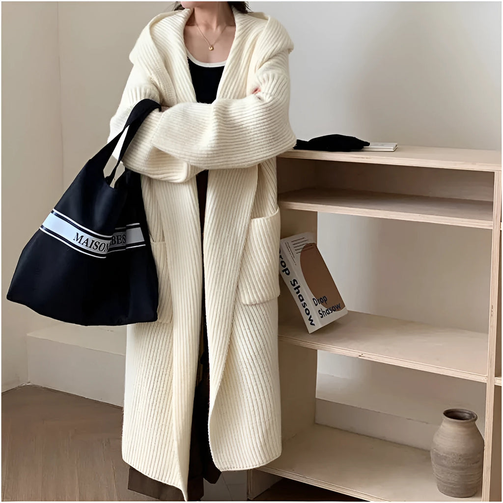 Women's milky white loose hooded cardigan coat with long raglan sleeves on a hanger.