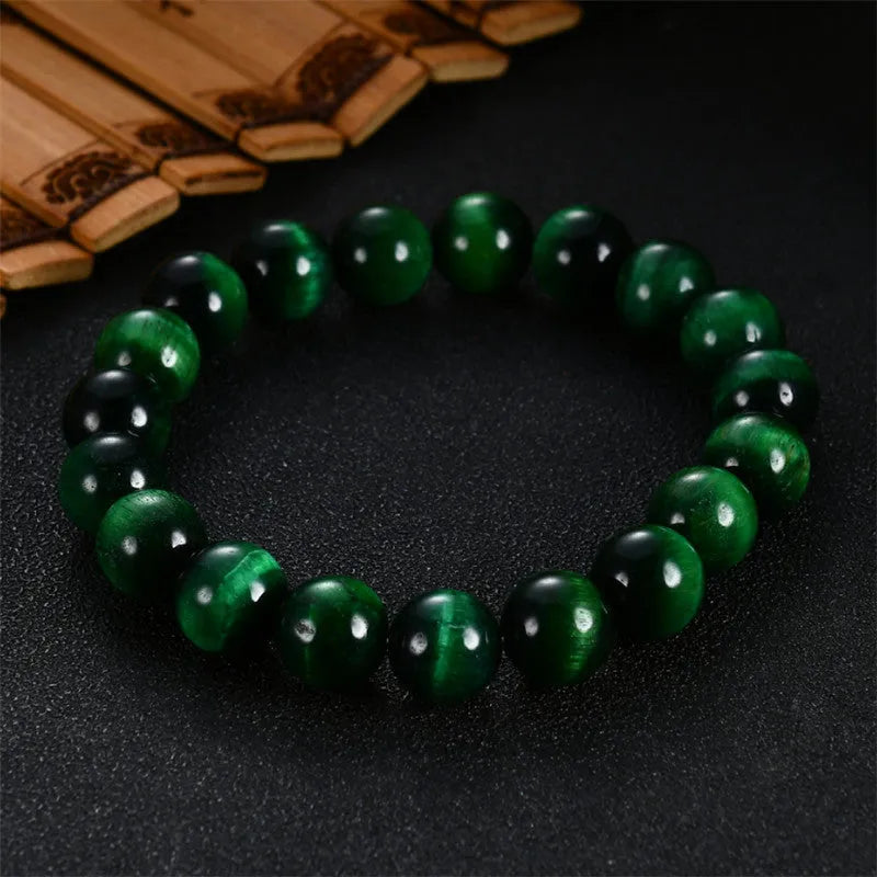 Green Tiger Eye stone bracelet with polished geometric beads on a wrist