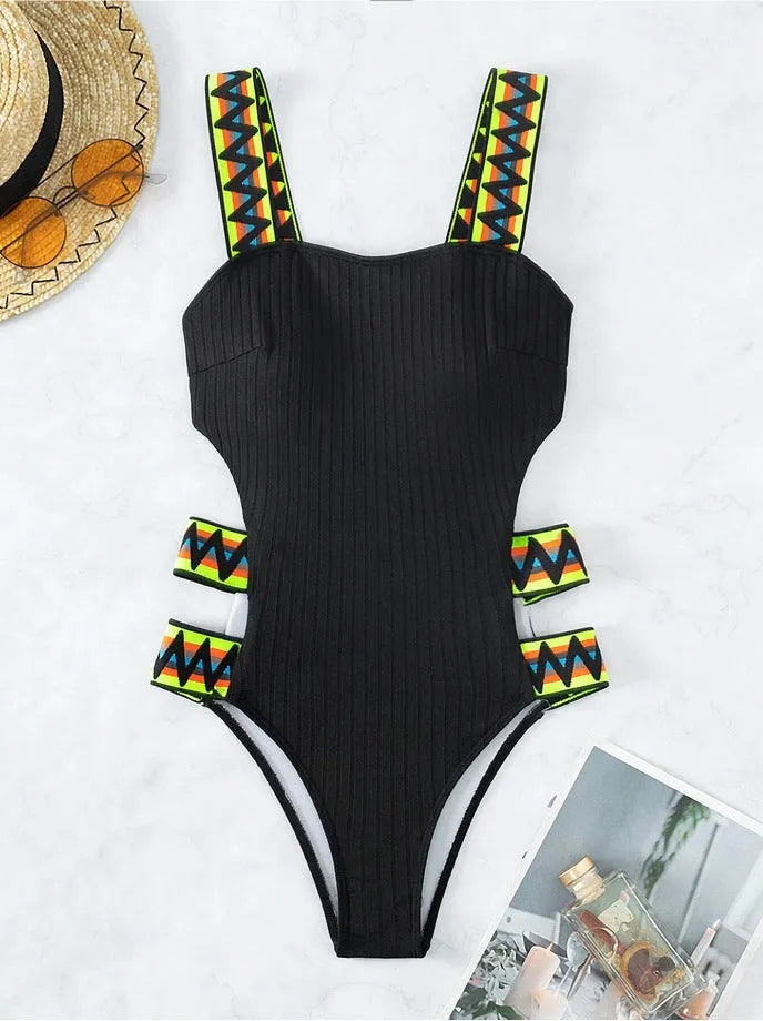 Black and orange solid colour women's one-piece polyester swimsuit on size chart.