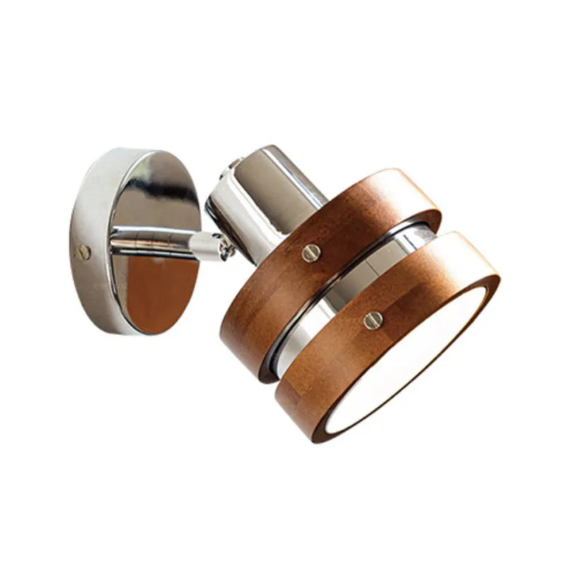Small Scandinavian-style wall lamp with walnut wood finish, mounted on a wall.