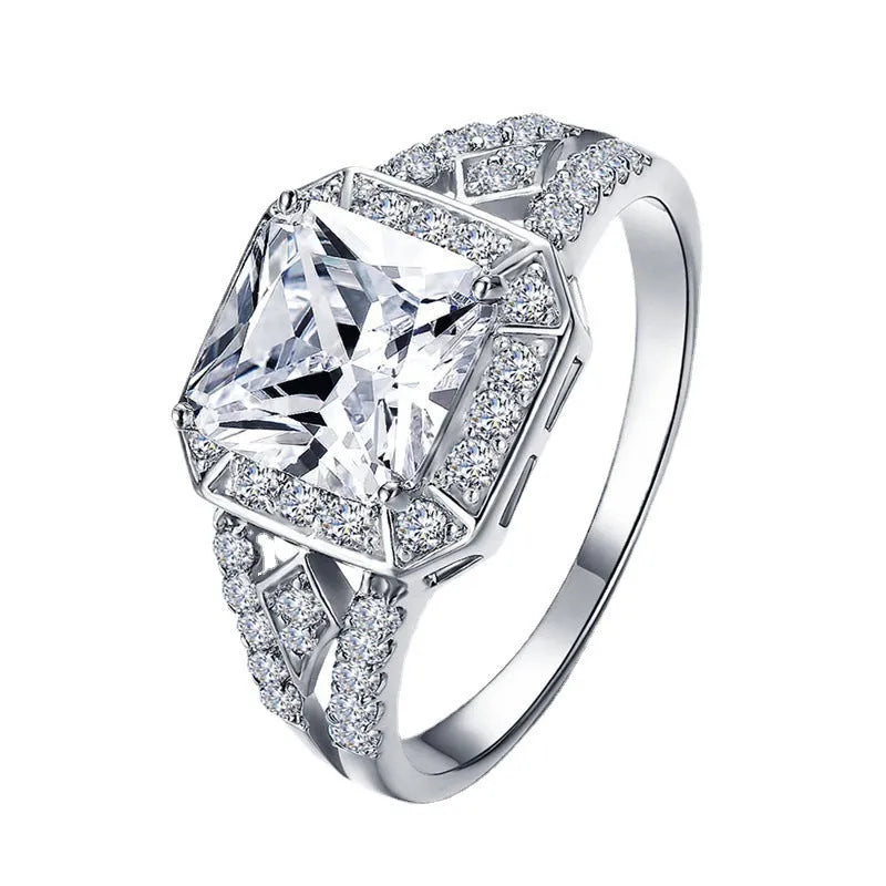 Platinum colour geometric women's ring with hollow design and inlaid zircon stone.
