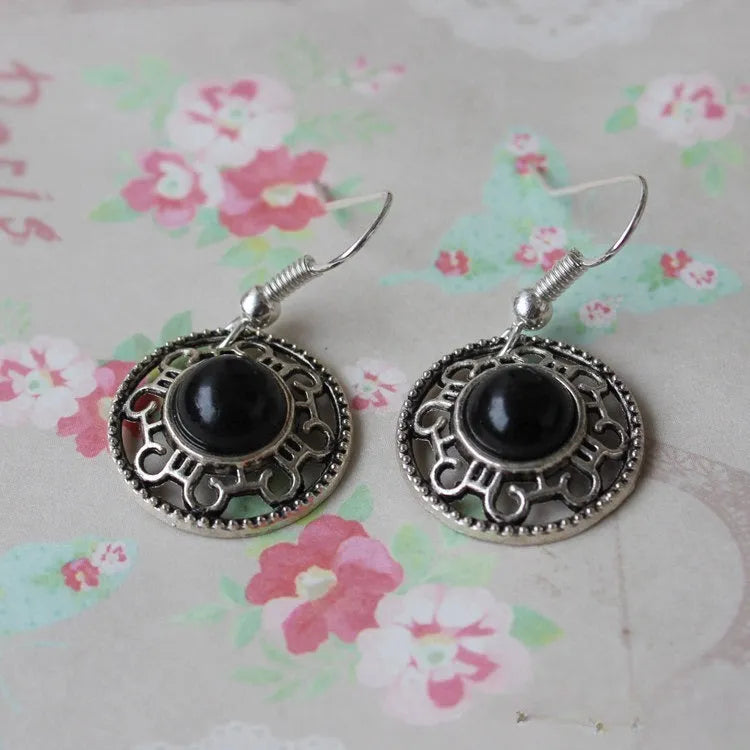 Handmade Miao silver and turquoise geometric flower disk earrings with ethnic patterns.