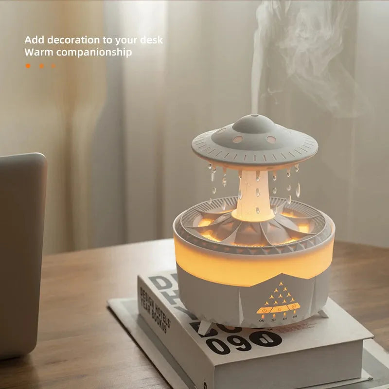White cloud-shaped humidifier with water droplets and coloured lights on wooden surface