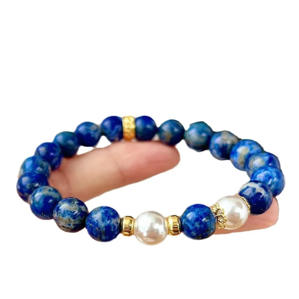 Chinese-style artistic retro lapis lazuli bracelet with green and gold stone on a white background.