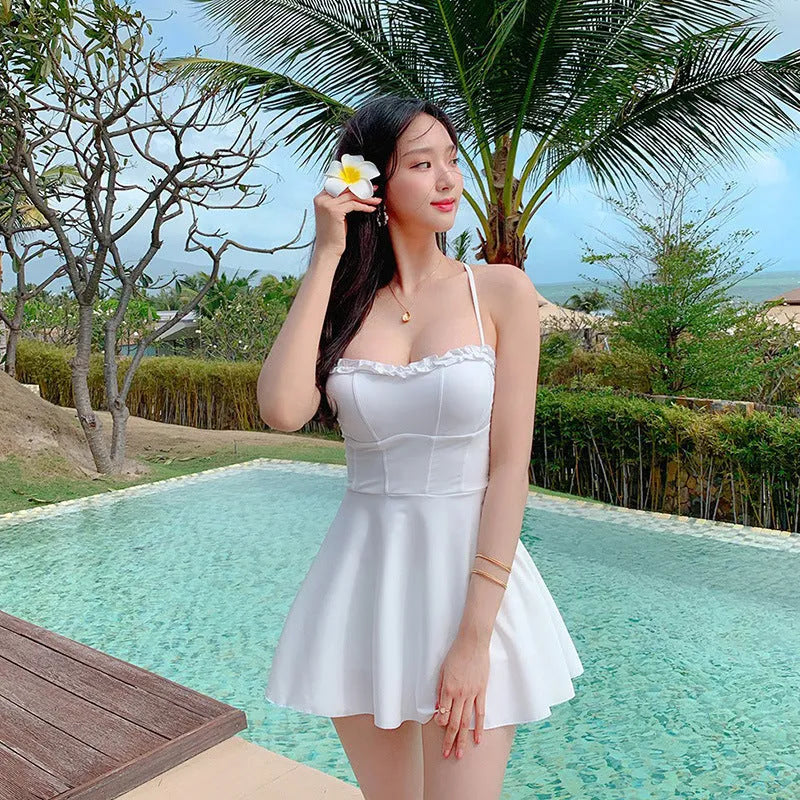 White women's one-piece swimsuit with hollow out design, shown on a mannequin.