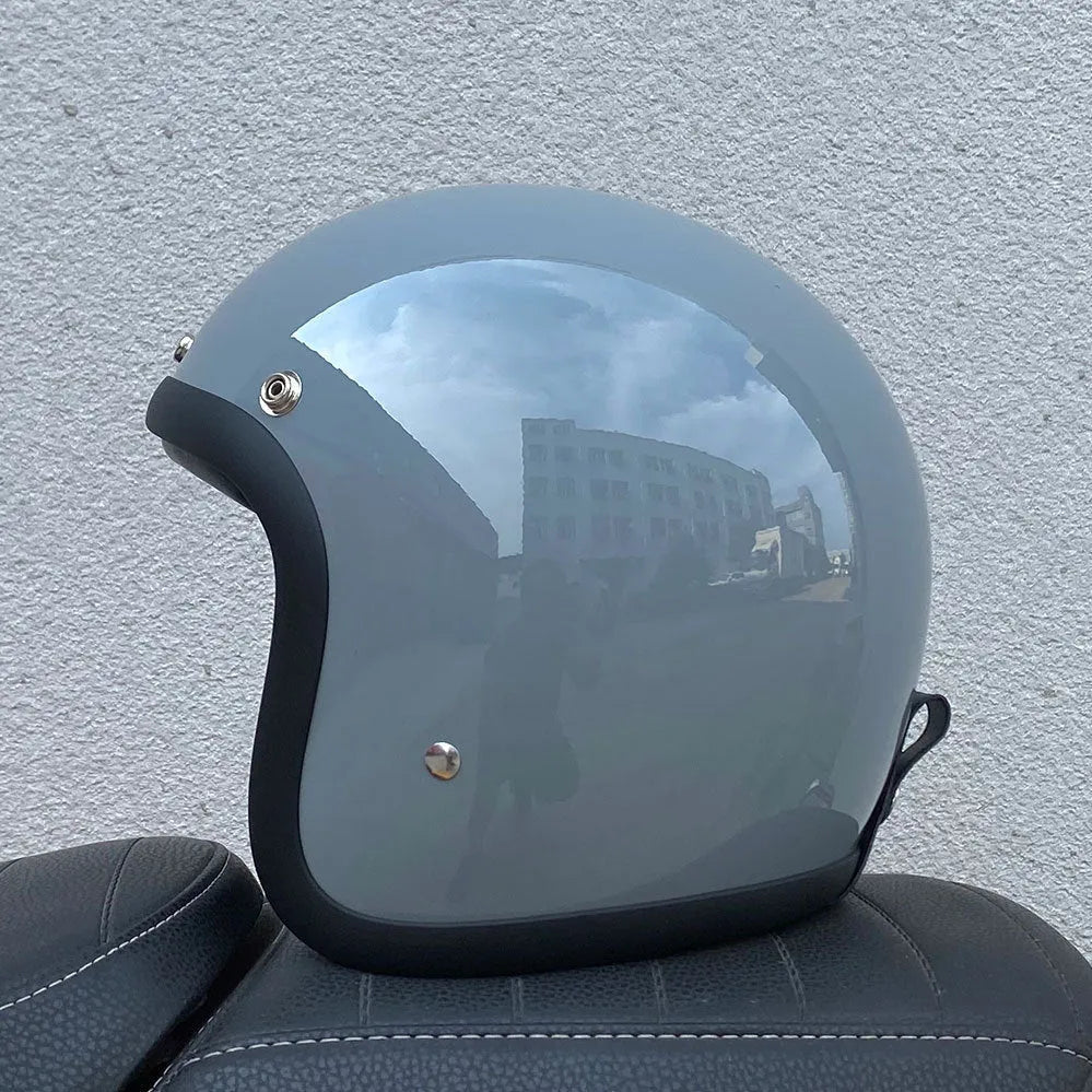 Retro-style glass fibre half motorcycle helmet shown in a selection of colours and prints.
