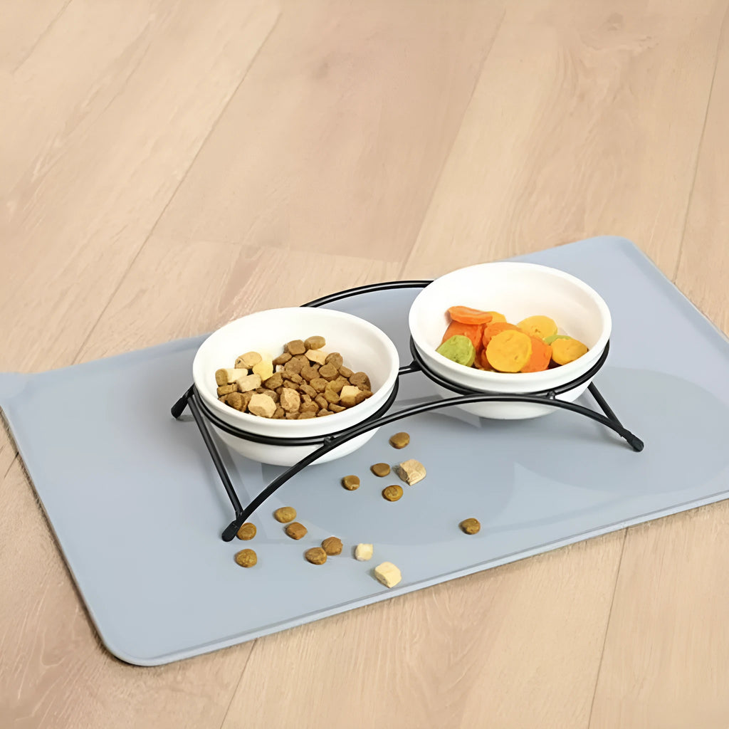 Silicone pet placemat for under food bowls in blue, shown next to a dog bowl.
