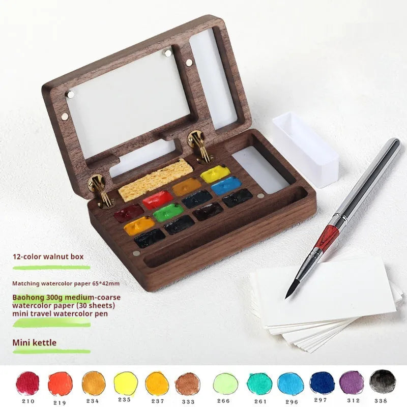 Mini walnut wood watercolour paint box open showing pigment colours inside with paint brush