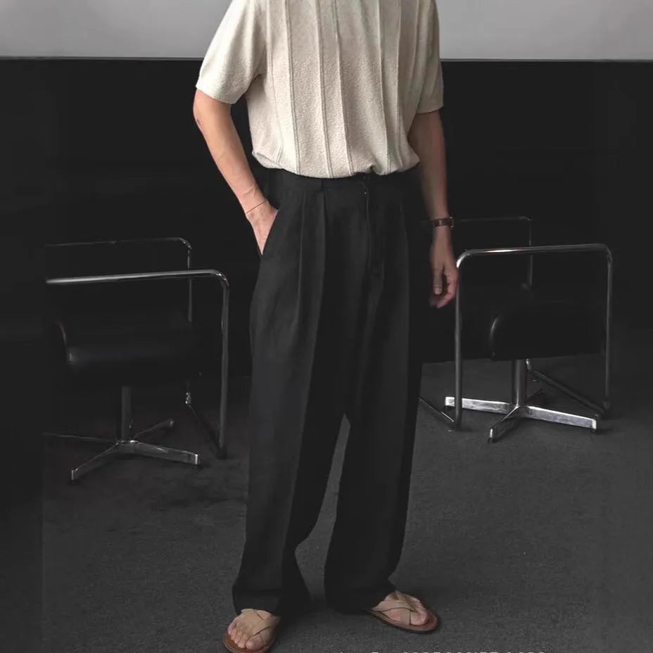 Men's loose-fit apricot cotton linen trousers with a mid-waist and pencil leg opening.