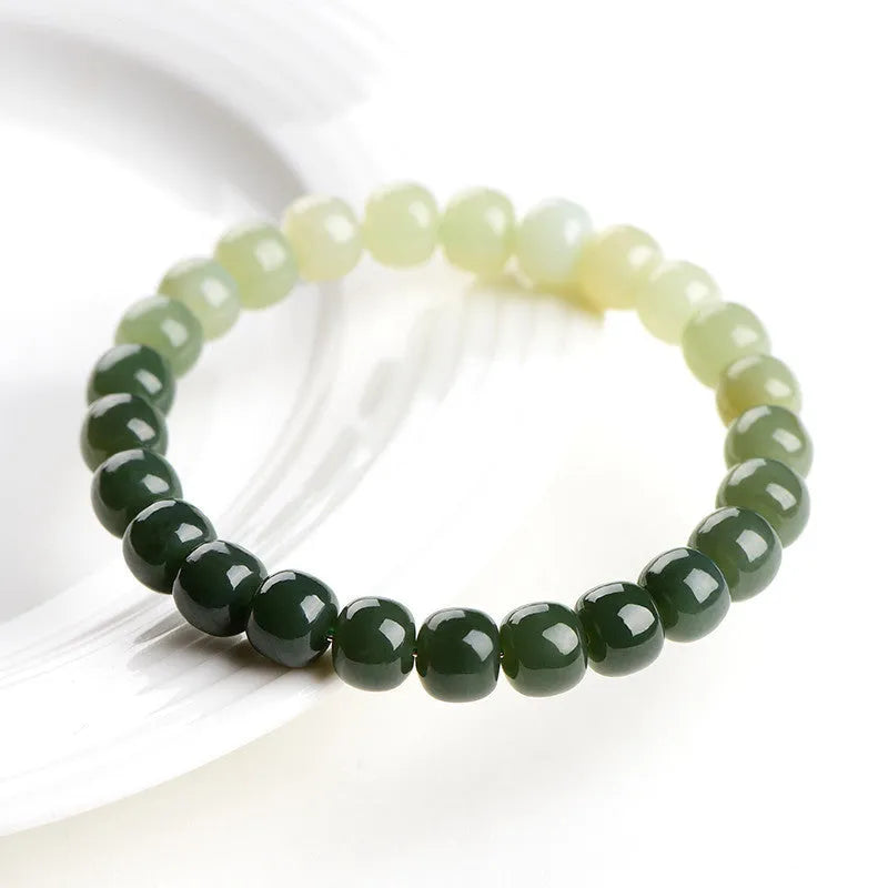 Natural Hetian Jade bracelet with gradient clear water colour on wrist, showing polished beads.