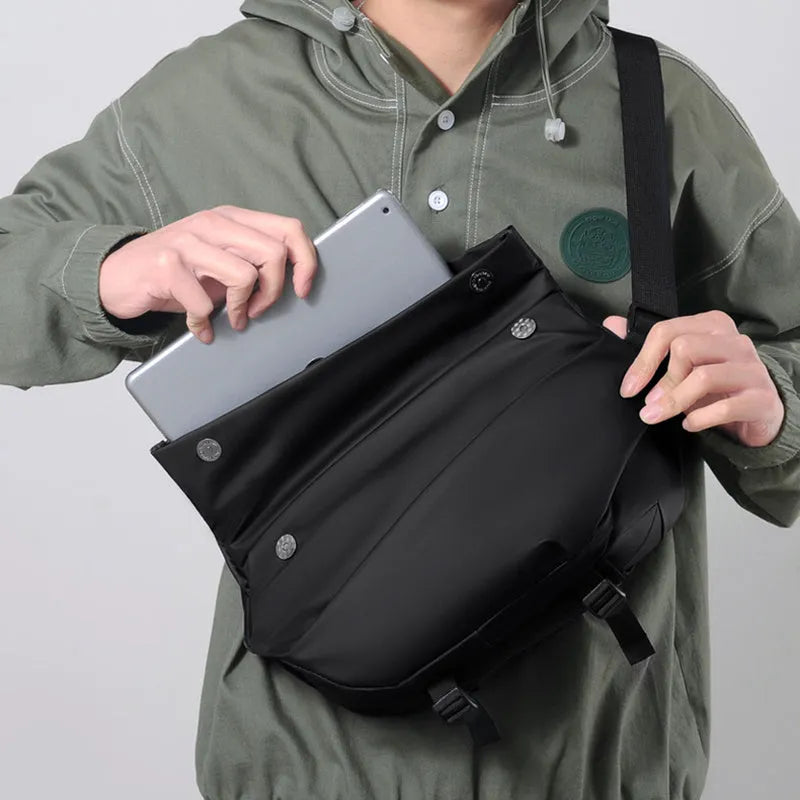 Grey horizontal square men's crossbody bag made of PU leather with a zipper and shoulder strap.