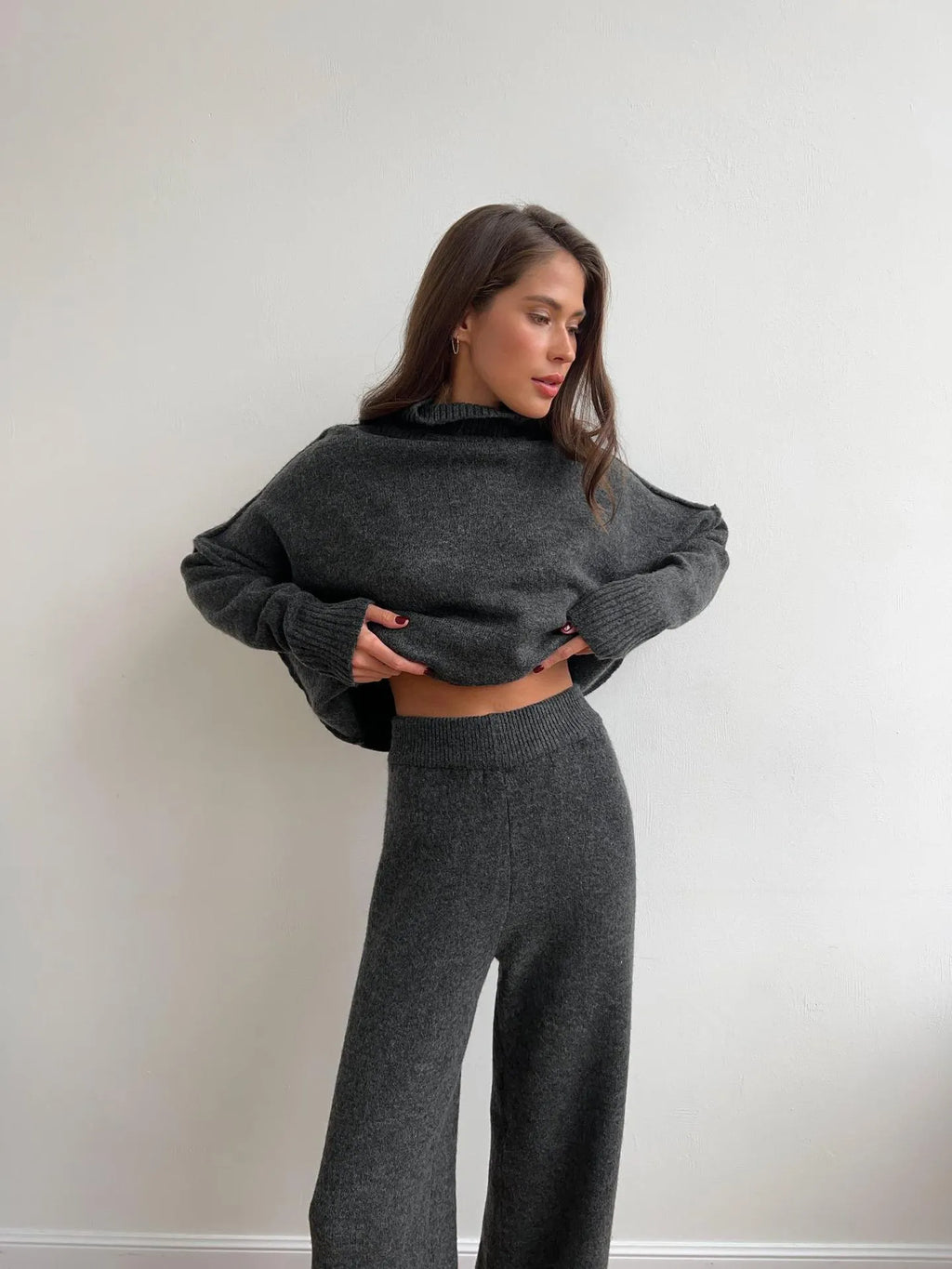Women's grey side-slit acrylic sweater and matching trousers suit set.