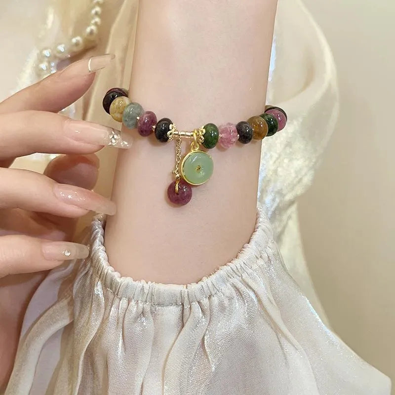 Colourful tourmaline abacus bead bracelet with rabbit pendant charm on wrist
