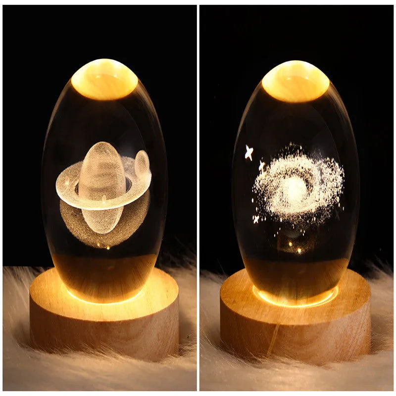 LED galaxy crystal ball night light with 3D planet designs on a table