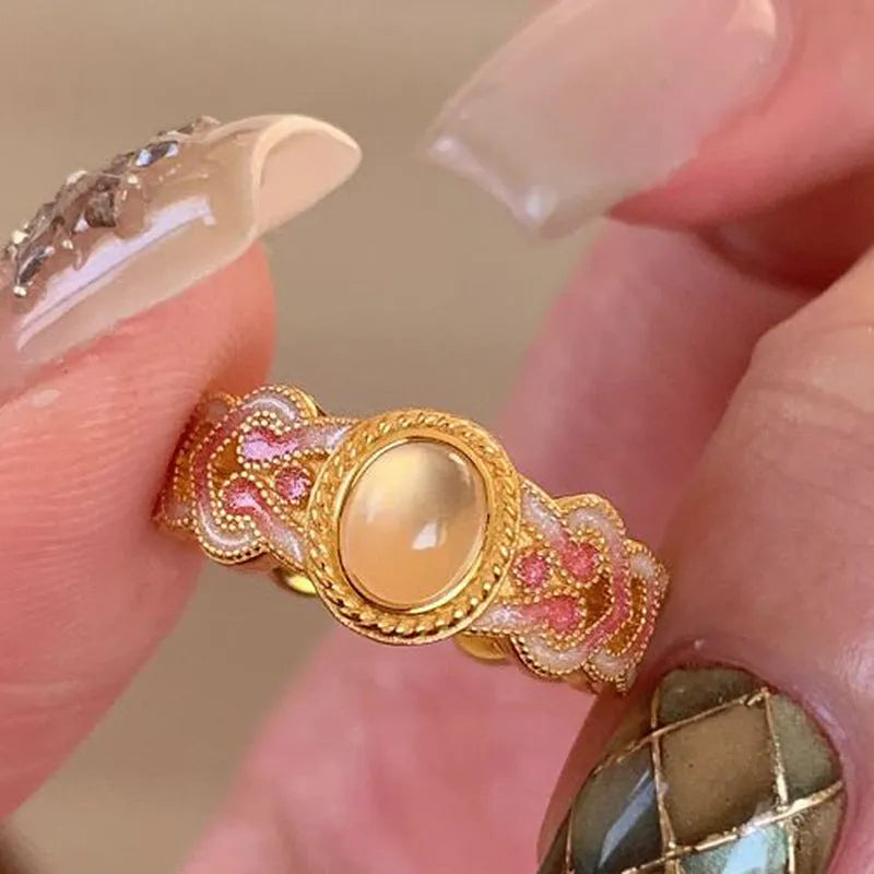 Women's geometric open ring with pink crystal enamel finish on adjustable copper gold plating