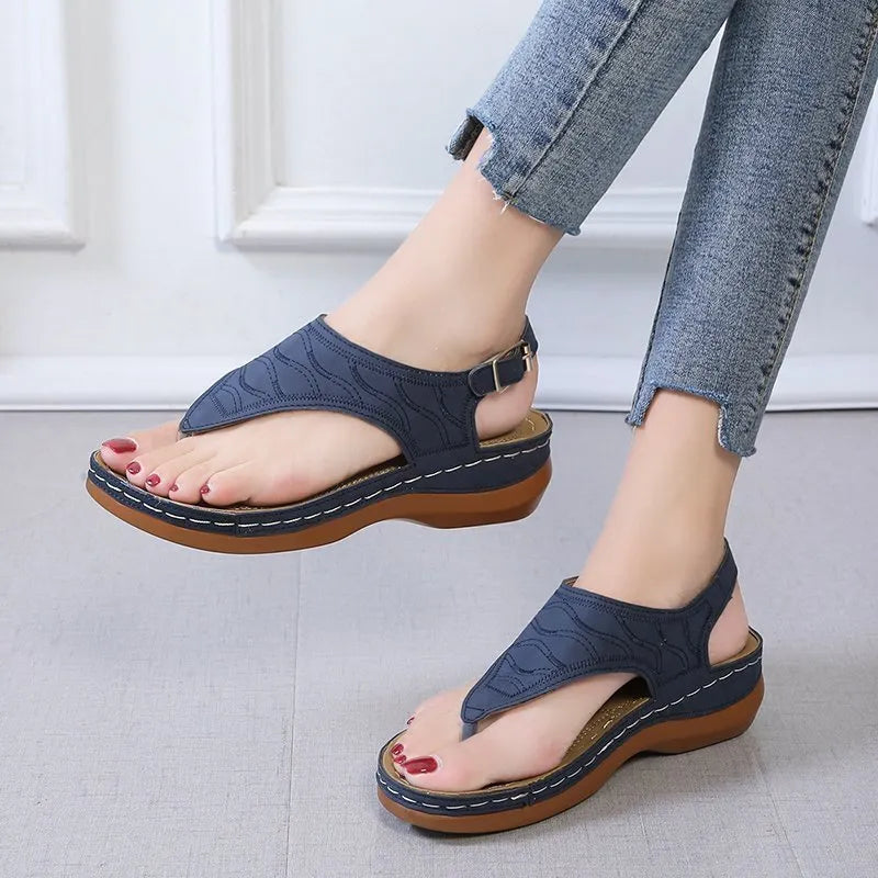 Women's black casual wedge heel sandals with an adjustable buckle strap on ankle.