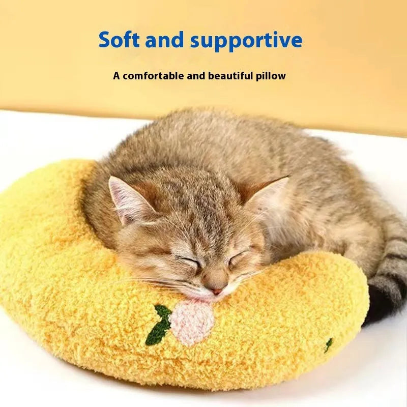 Blue U-shaped cat pillow with a Question Mark design on a wooden floor.