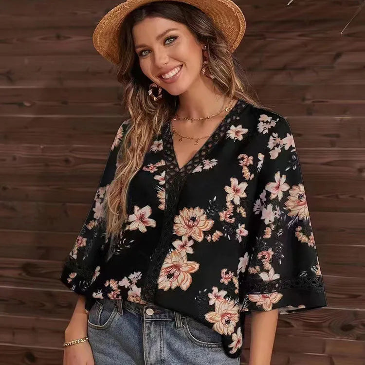 Loose V-neck pullover top with bell sleeves, lace trim, and printed pattern in white