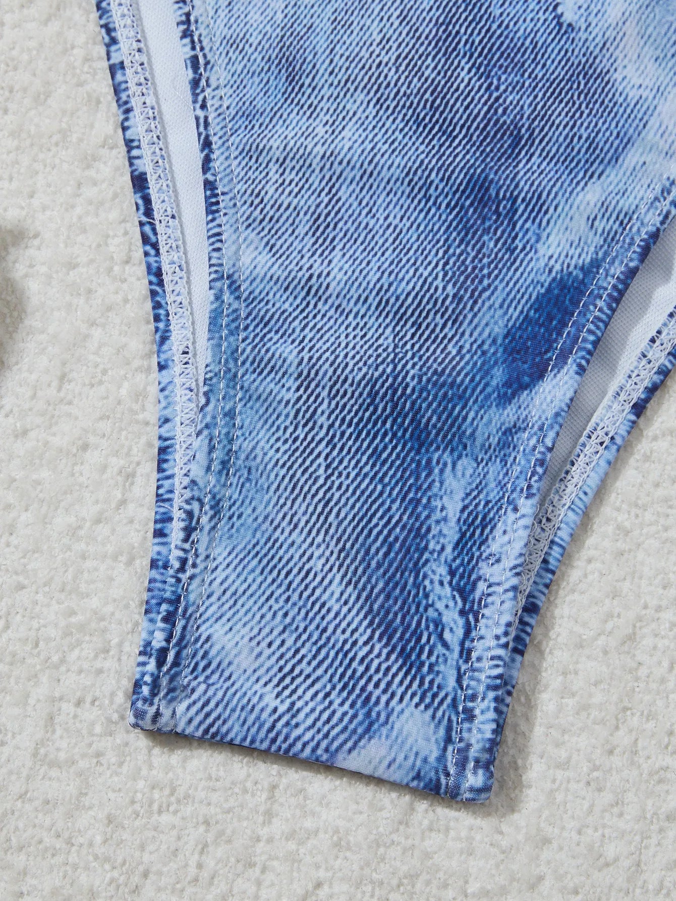 Denim blue printed women's bikini set with strap design on a mannequin.