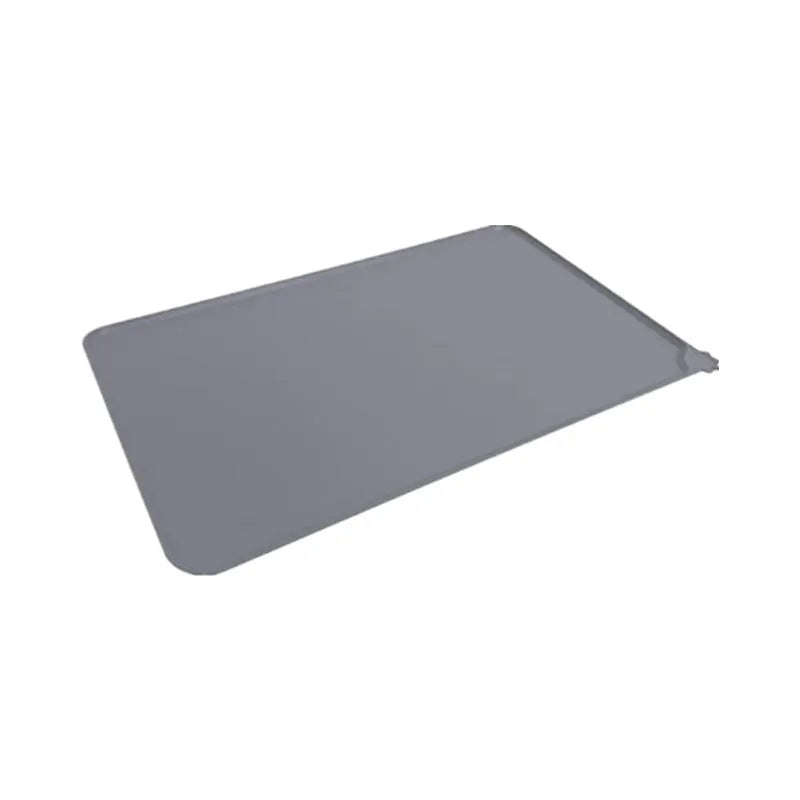 Silicone pet placemat for under food bowls in blue, shown next to a dog bowl.