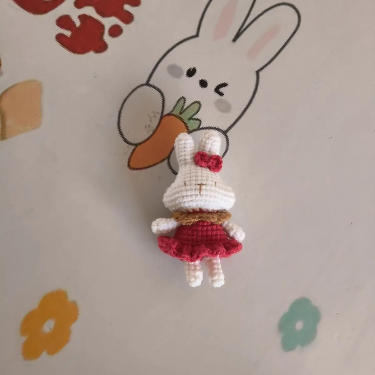 Hand-crocheted wool rabbit keychain pendant on a metal ring.