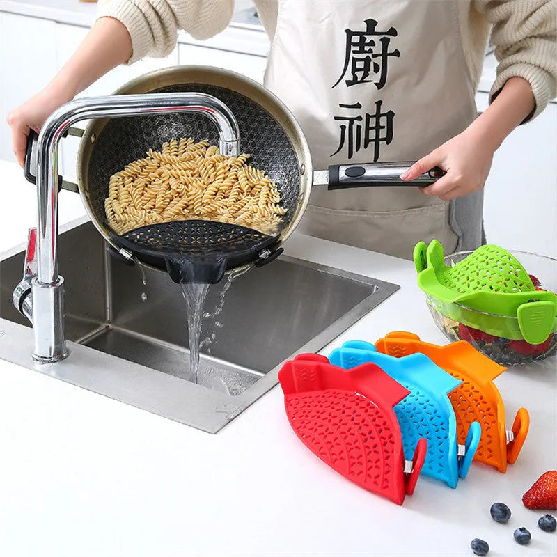 Green silicone pot side drain stopper kitchen gadget with stainless steel on wooden surface