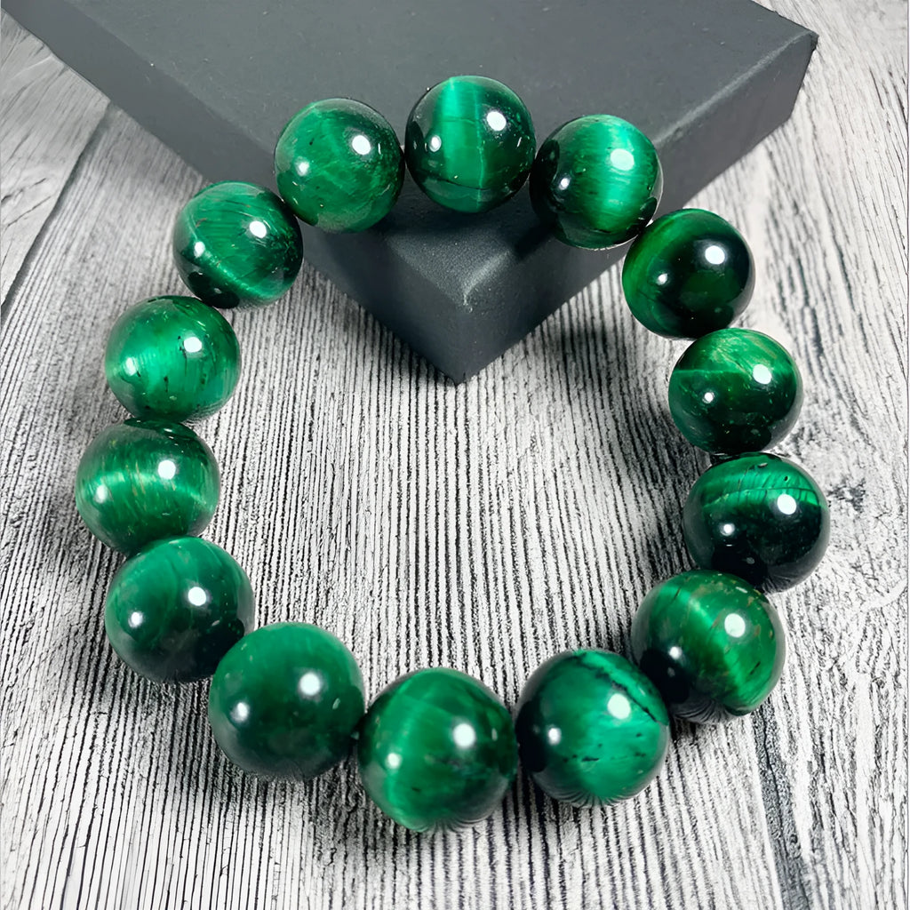 Green Tiger Eye stone bracelet with polished geometric beads on a wrist