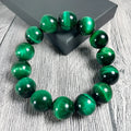 Green Tiger Eye stone bracelet with polished geometric beads on a wrist