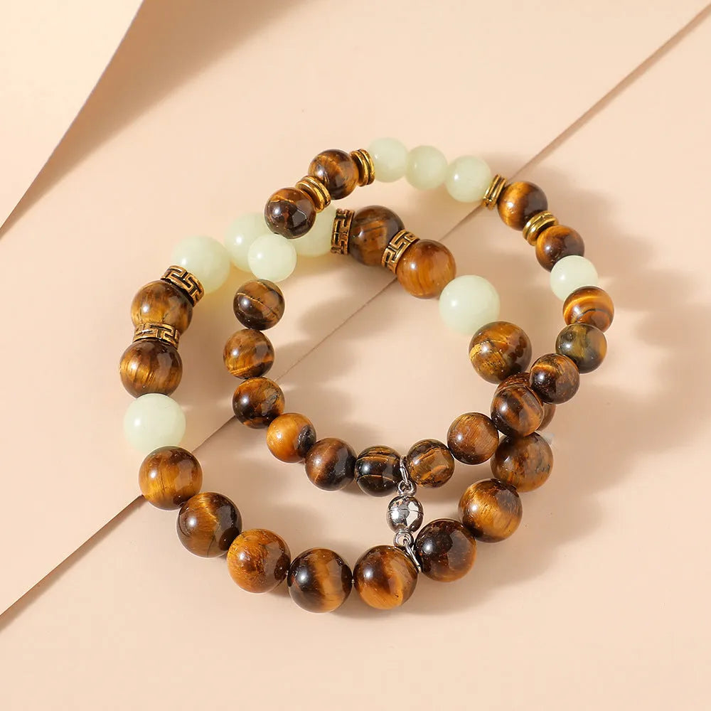 Geometric amber couple bracelets with luminous retro styling on display