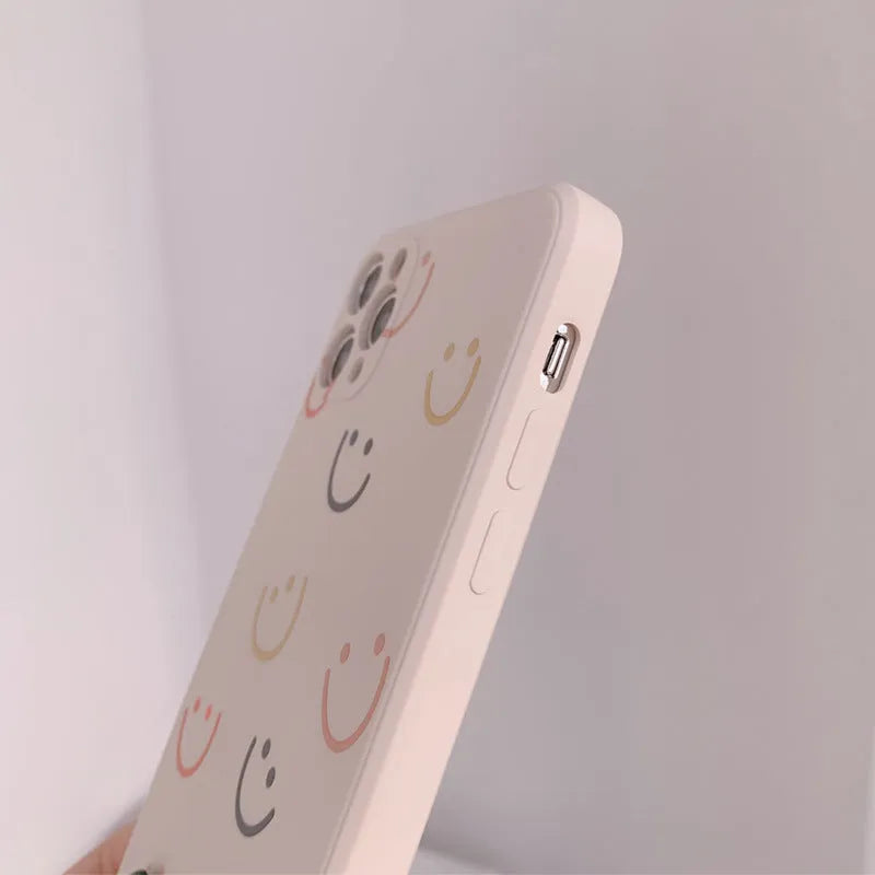 Simple TPU iPhone case with painted smiley face design in three colour options