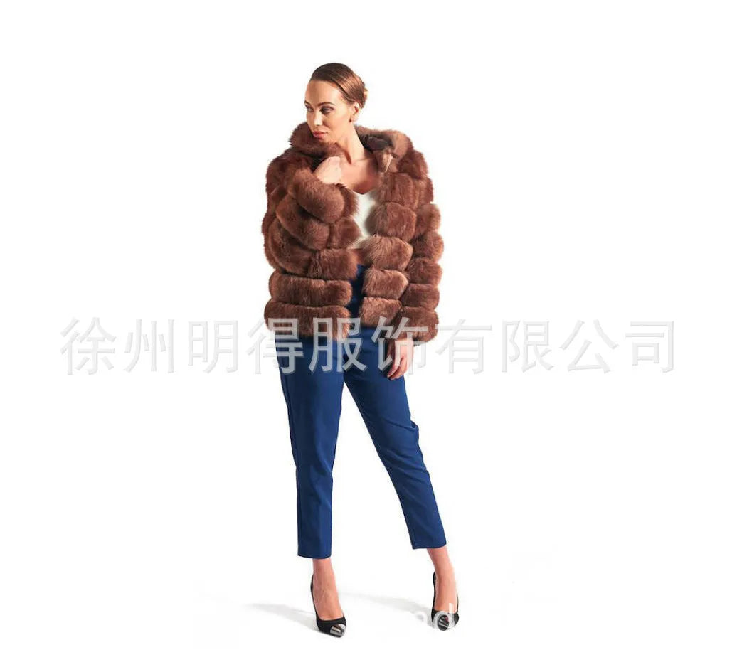 A woman wearing a loose-fit brown artificial fur hooded coat of medium length.