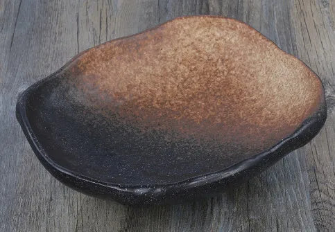 Japanese style irregular shaped ceramic sashimi bowl with floral decoration and sauce dish