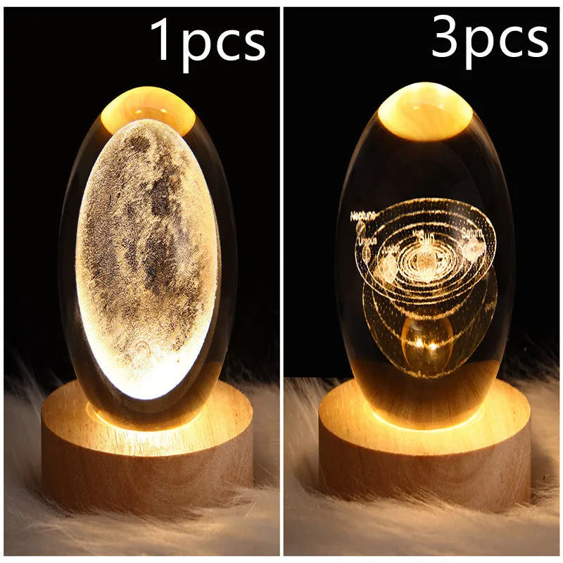 LED galaxy crystal ball night light with 3D planet designs on a table