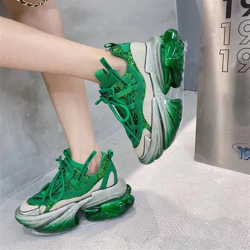 Women's green leather sports shoes with a thick translucent jelly sole and a white cross-tie strap.