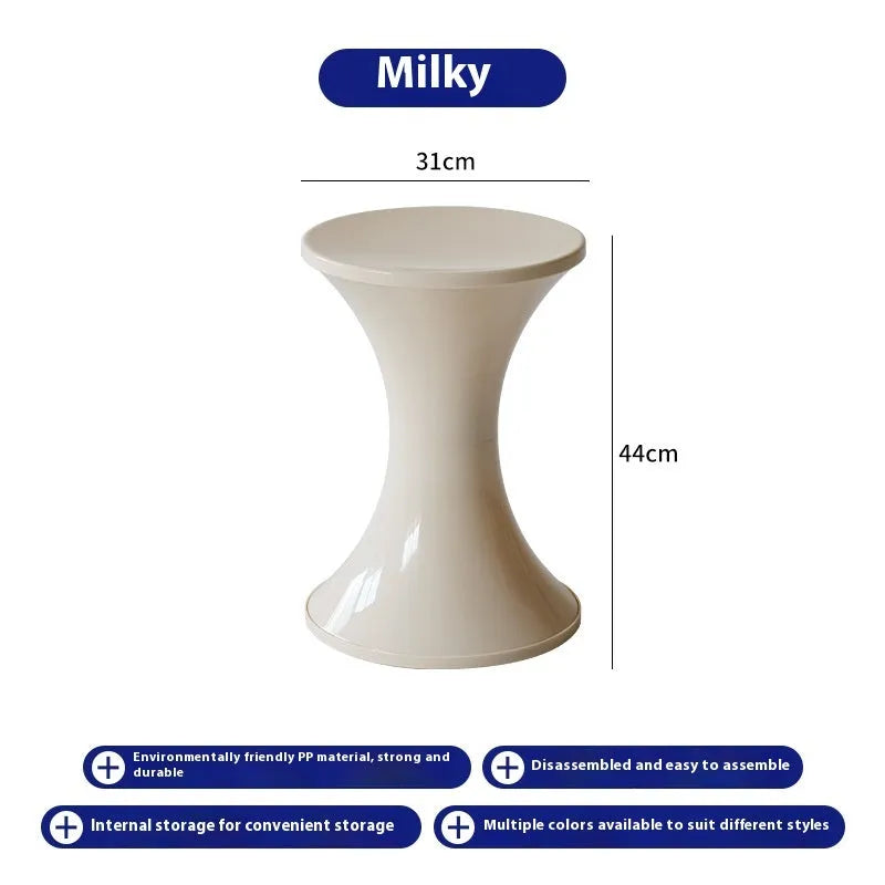 Creative hourglass-shaped plastic stool for changing shoes, shown in a green colour.