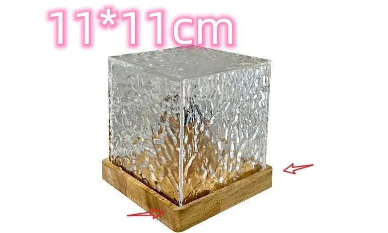 LED water ripple night light with rotating crystal projection and remote control on wooden surface