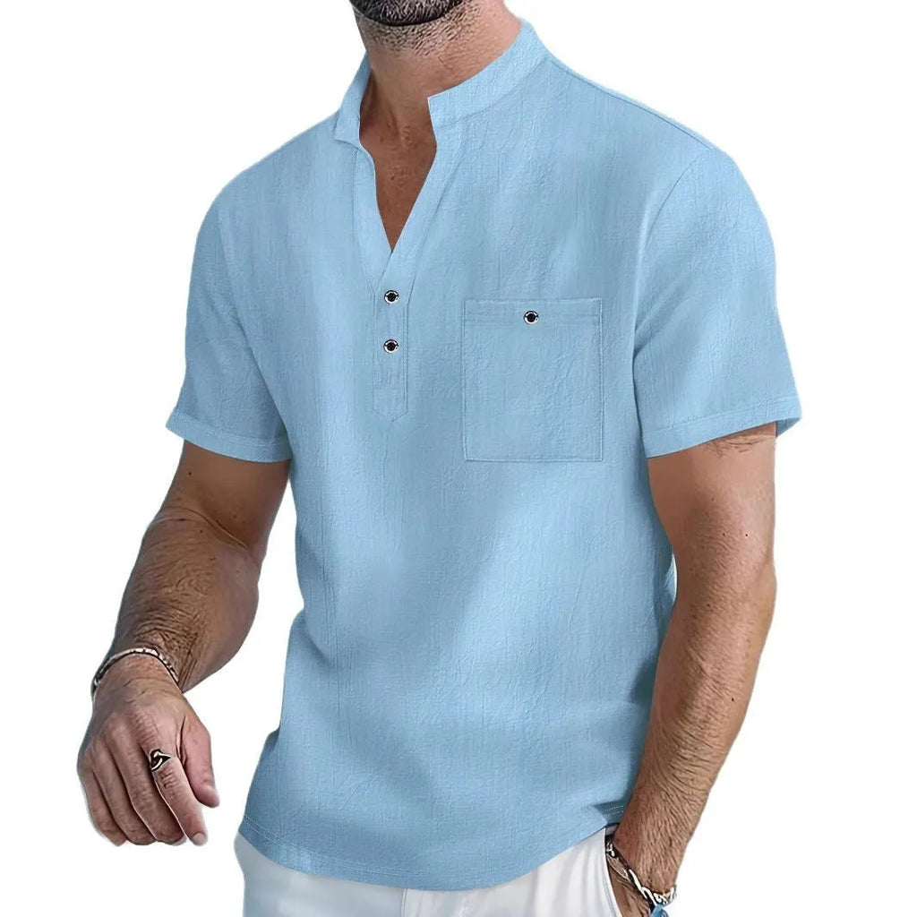 Man wearing a light apricot-coloured linen stand collar short sleeve shirt with a loose fit.