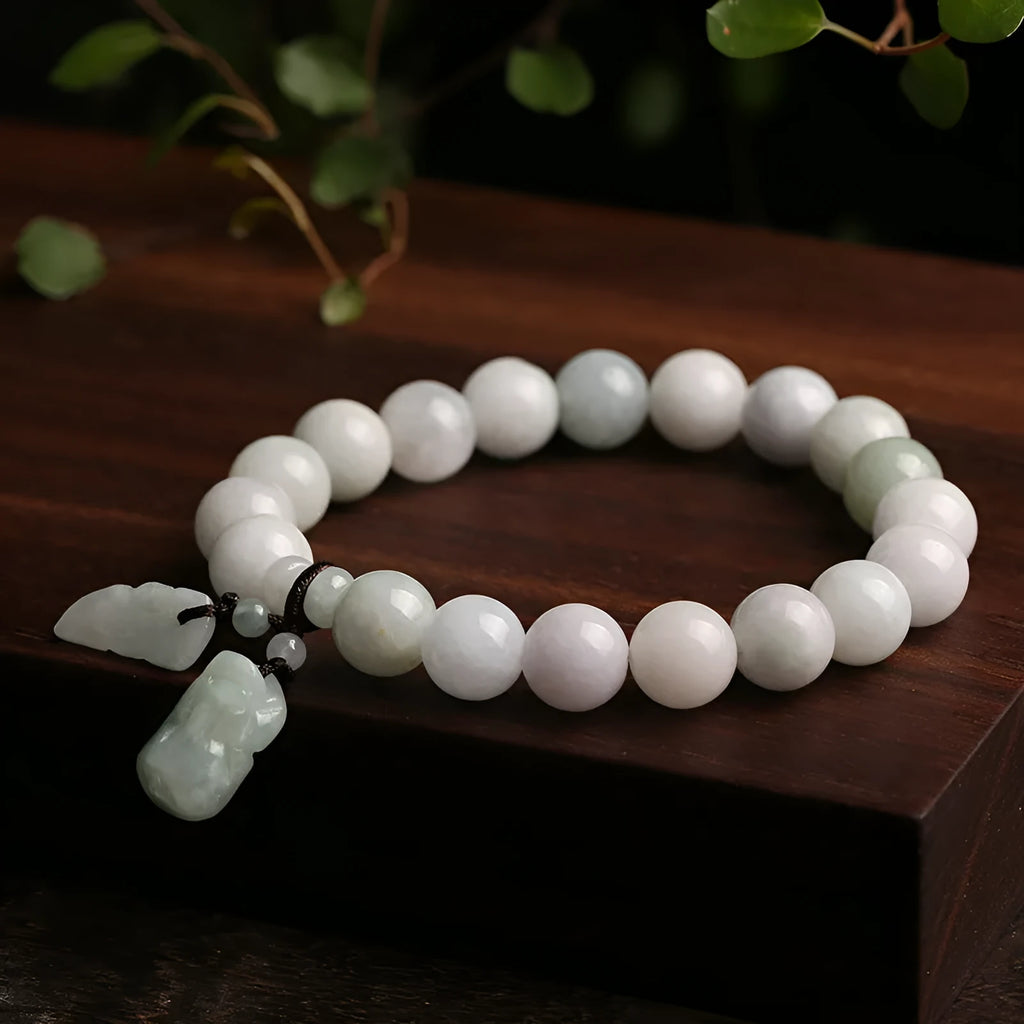 Emerald green jade hanging bracelet with Maitreya Buddha charm and geometric shapes