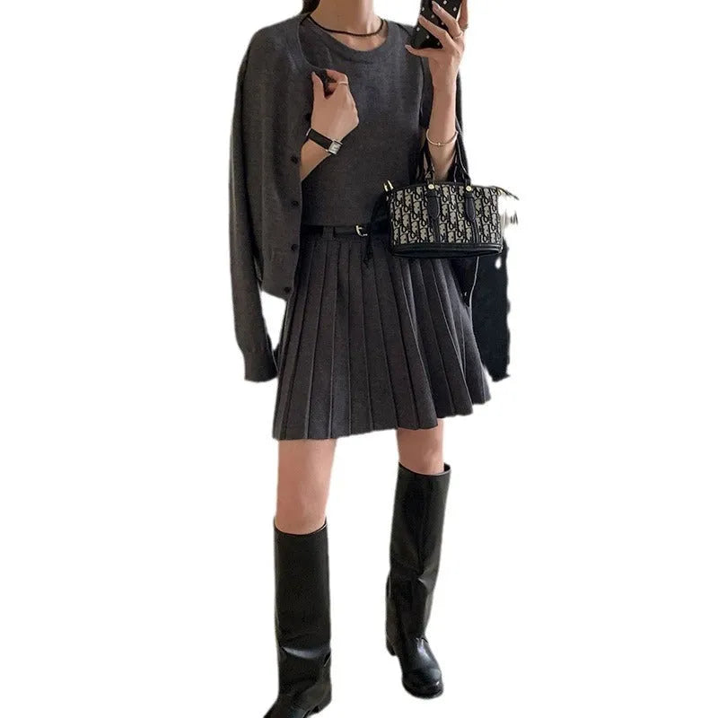 Women's black art retro knitted two-piece set with long-sleeve cardigan, pleated vest skirt, and a belt.