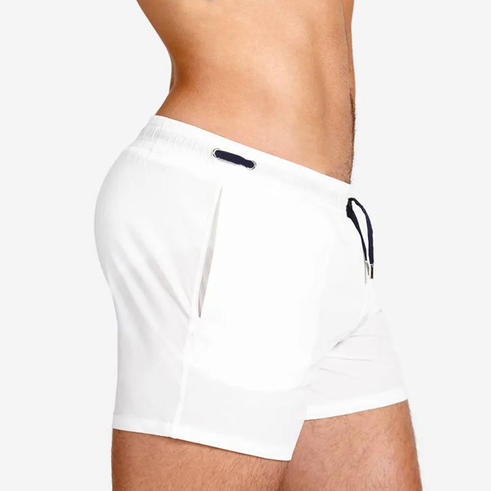 Pair of solid colour sports shorts with mesh lining for swimming and fitness training.