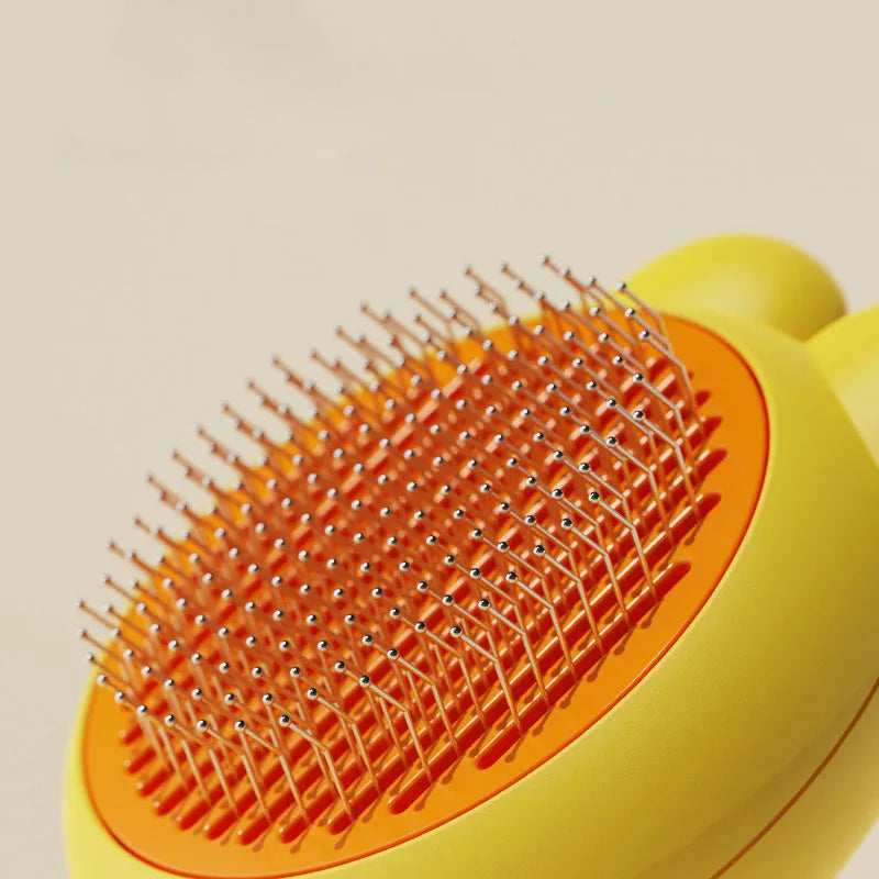 Self-cleaning pet grooming brush with stainless steel comb and comfort-grip handle in multiple colours