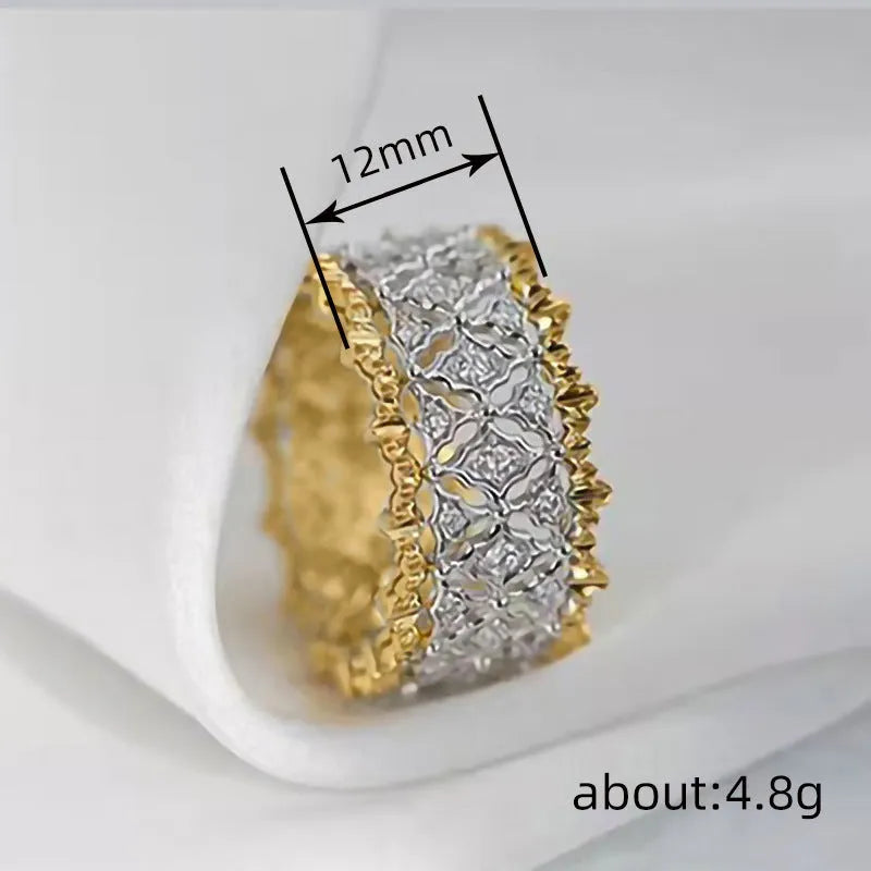 A geometric two-tone gold ring with a round zircon detail on a copper band.