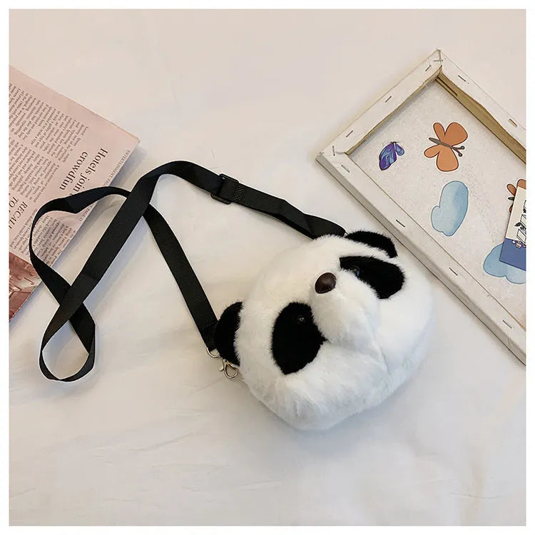 Soft plush crossbody bag with panda head design, shown in cylindrical shape.