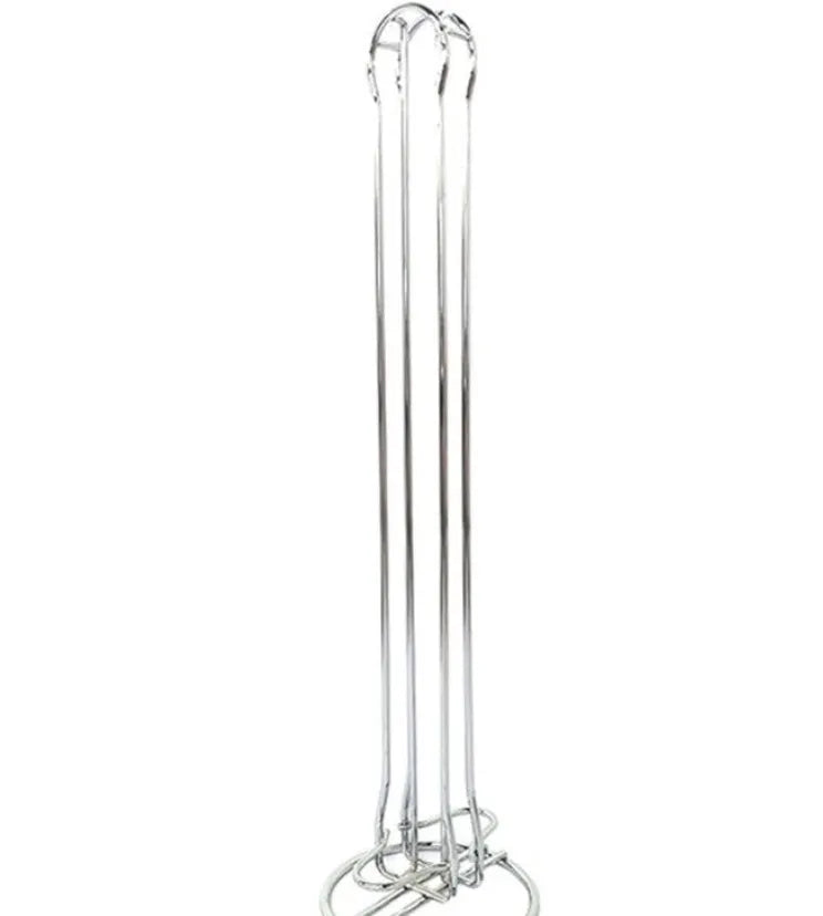 Black wrought iron coffee capsule storage rack holding pods on a kitchen counter