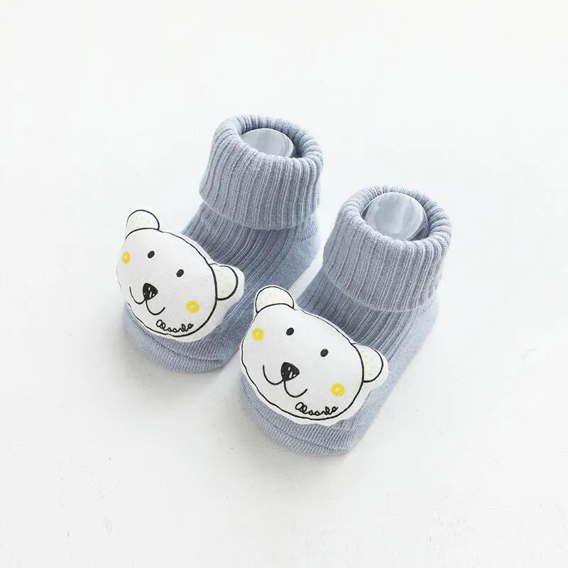 Baby socks with anti-slip glue dots on soles in combed cotton, showing mid-tube height and various colour options