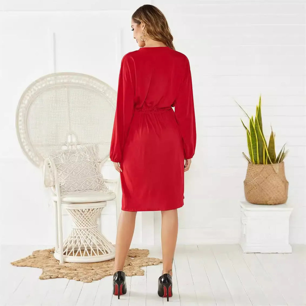 Black A-line midi dress with long sleeves, elastic cuffs, and a belt at the elastic waist.