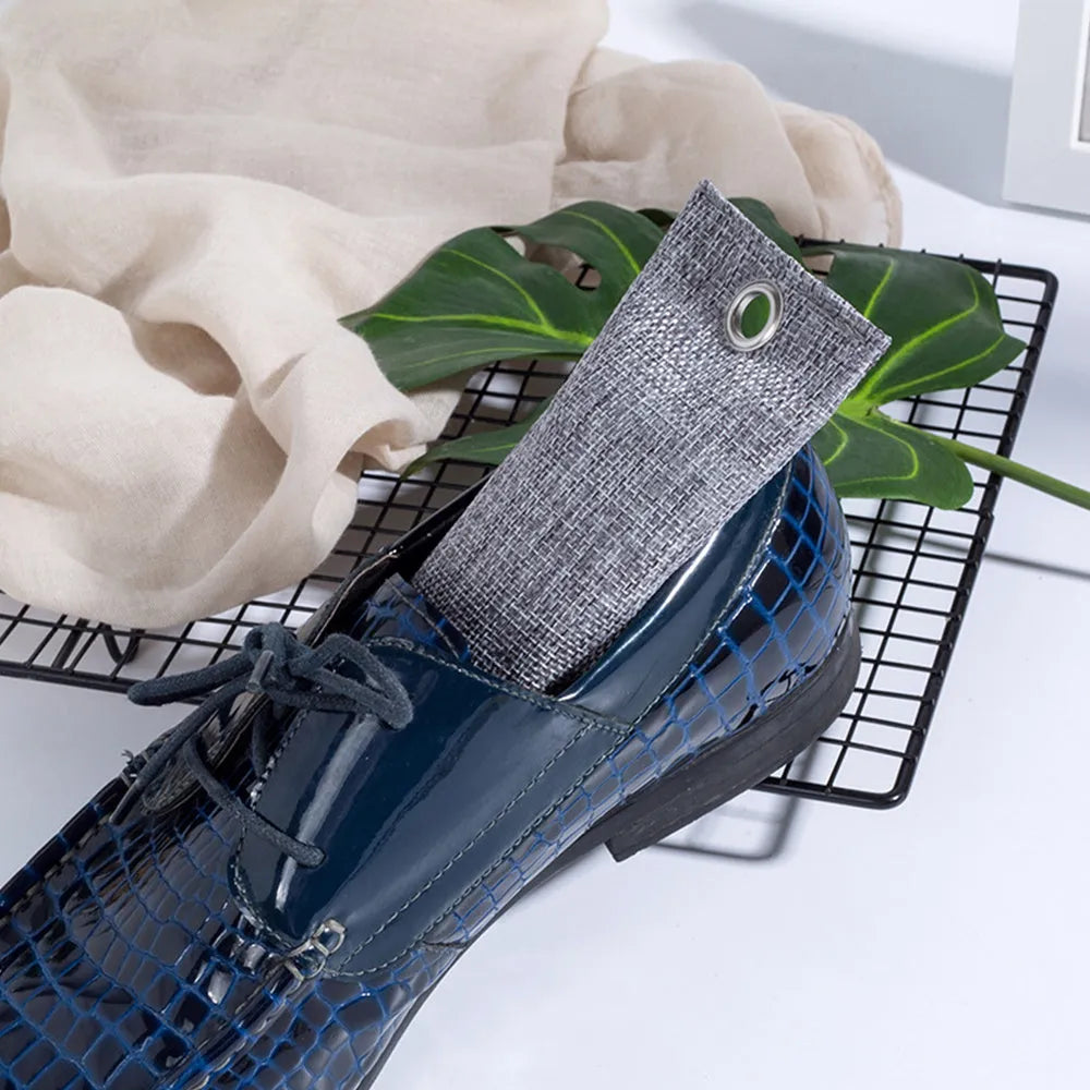 Black, green, grey, and blue bamboo charcoal deodoriser bags for shoes and household odour absorption.